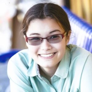 Photo of person with brown hair and dark glasses
